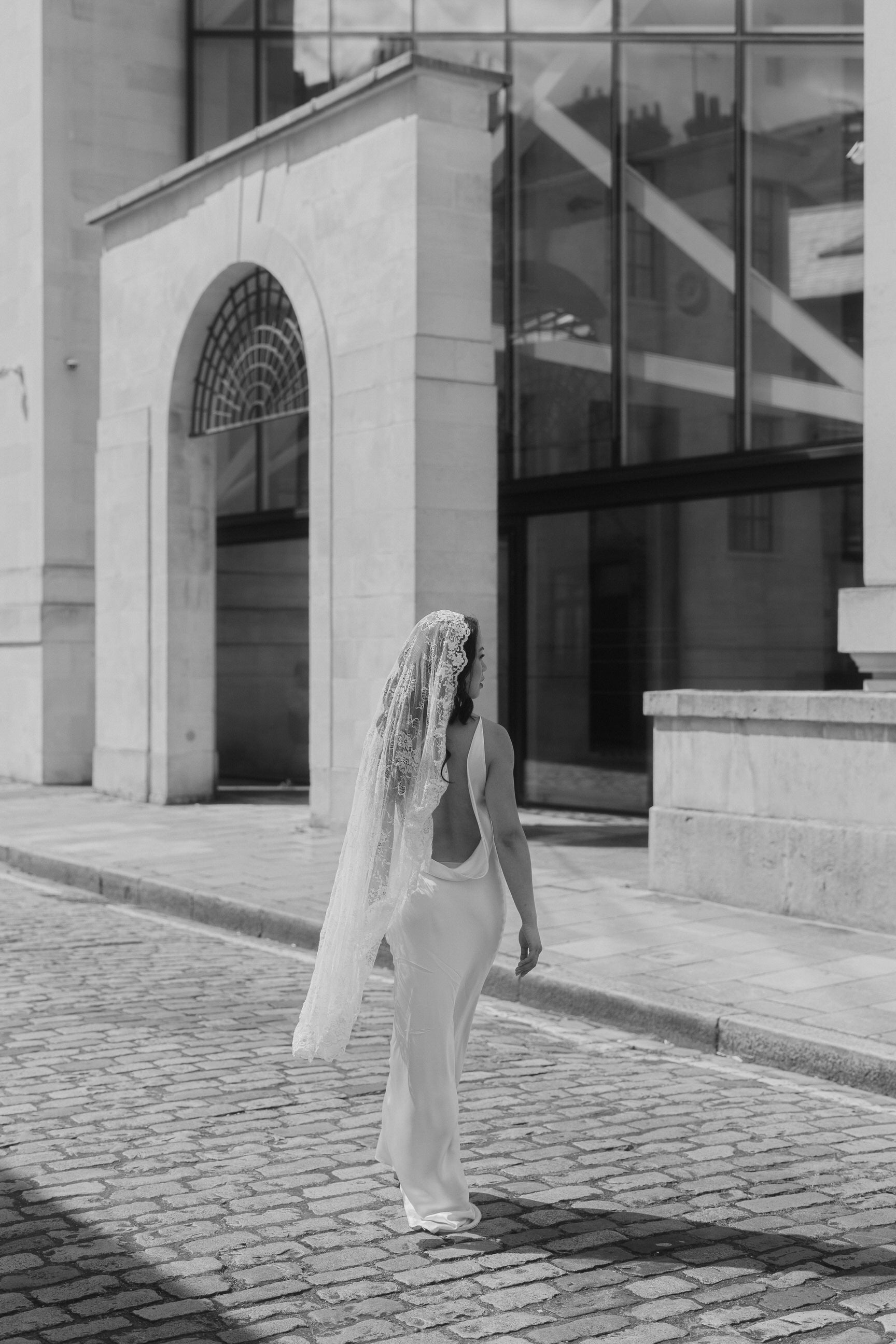 romantic Chantilly lace mantel wedding veil knee length on bride wearing low back wedding dress