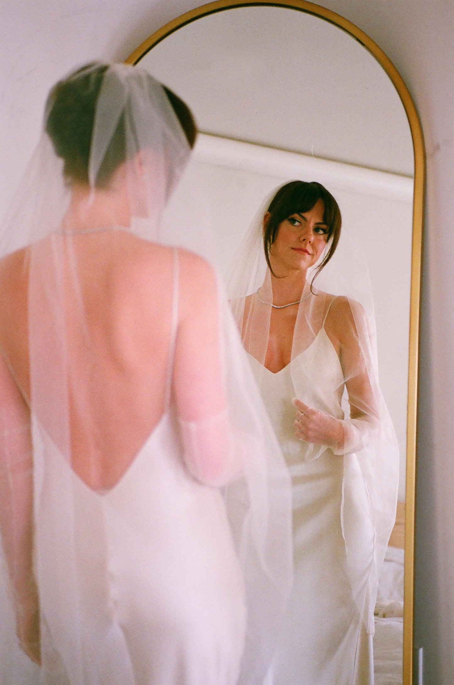 soft white knee length bridal veil with thin ribbon edge on angel cut veil