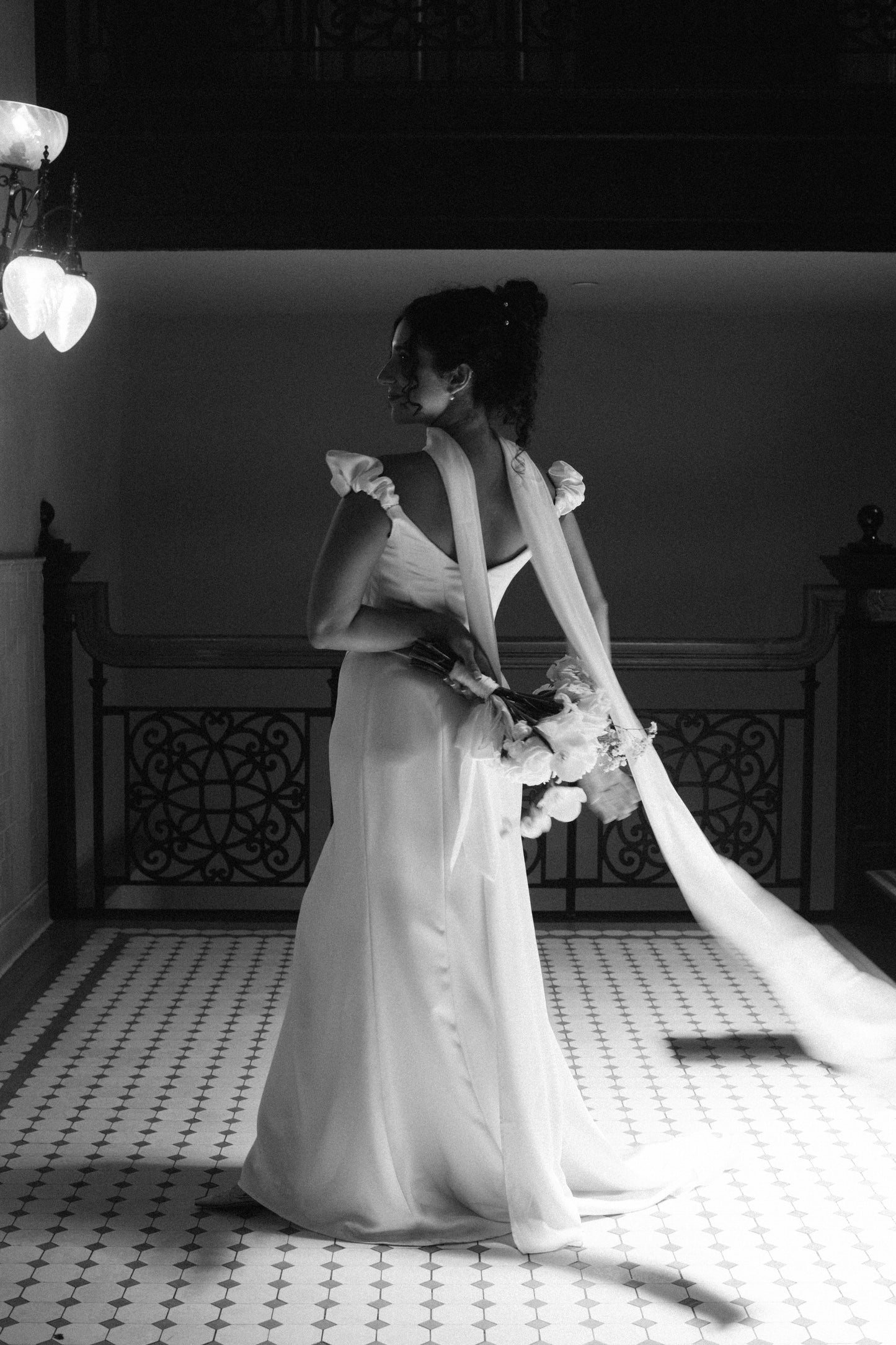 back view of pretty bride in long chapel length silk scarf around neck