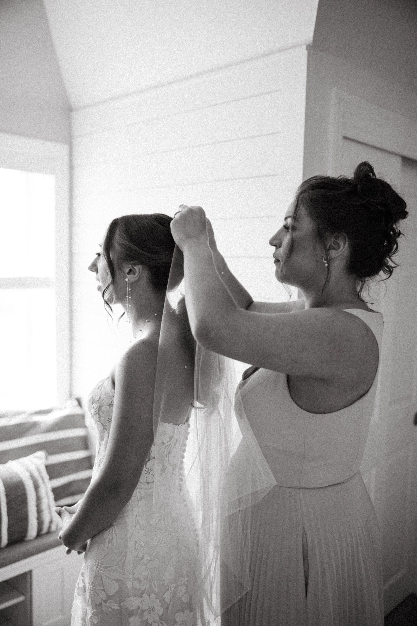 elegant pearl ponytail bridal veil on bride wearing curled updo hair and strapless beaded gown
