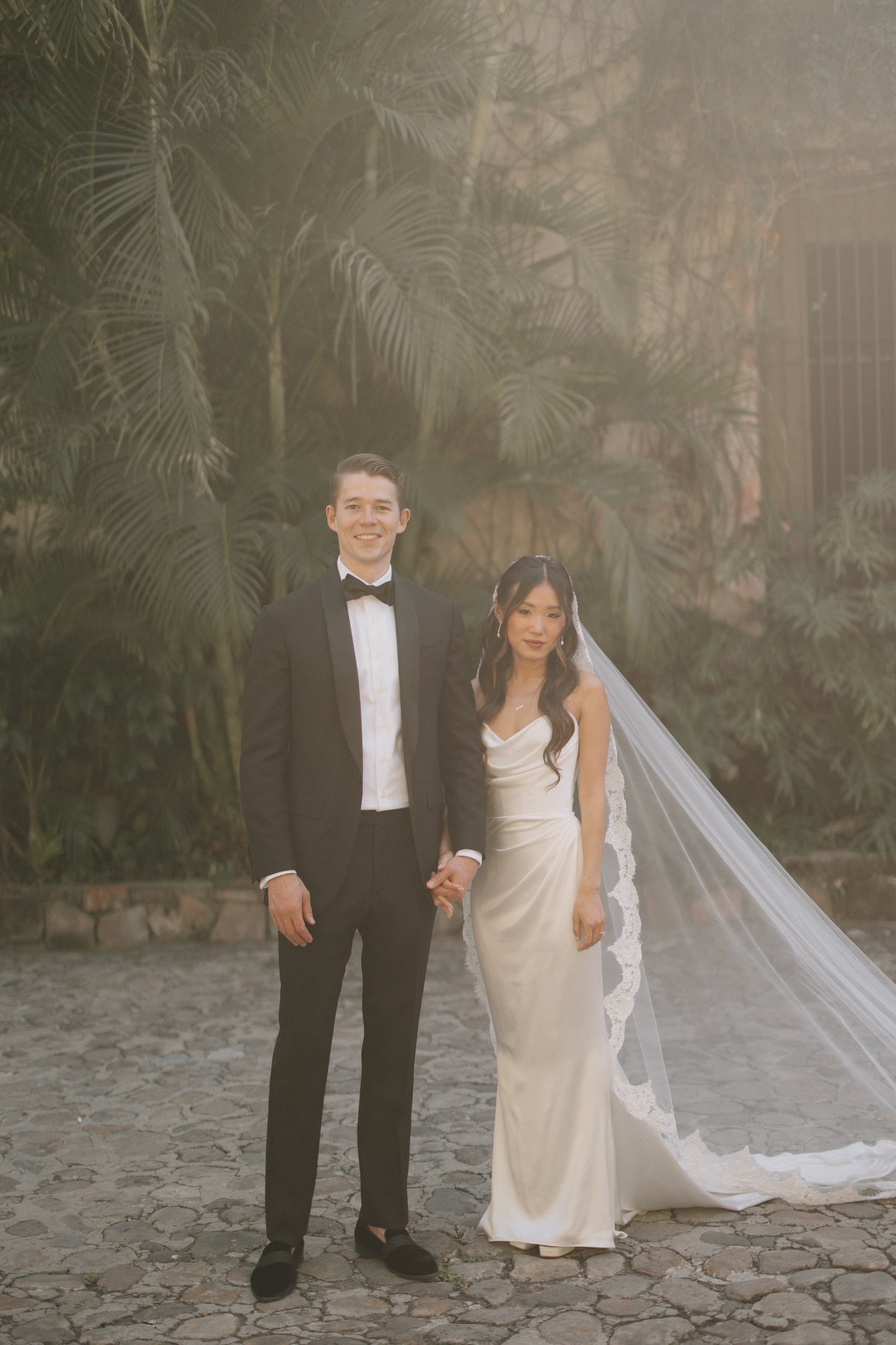 romantic bride in lace wedding veil cathedral length with strapless mikado classic gown