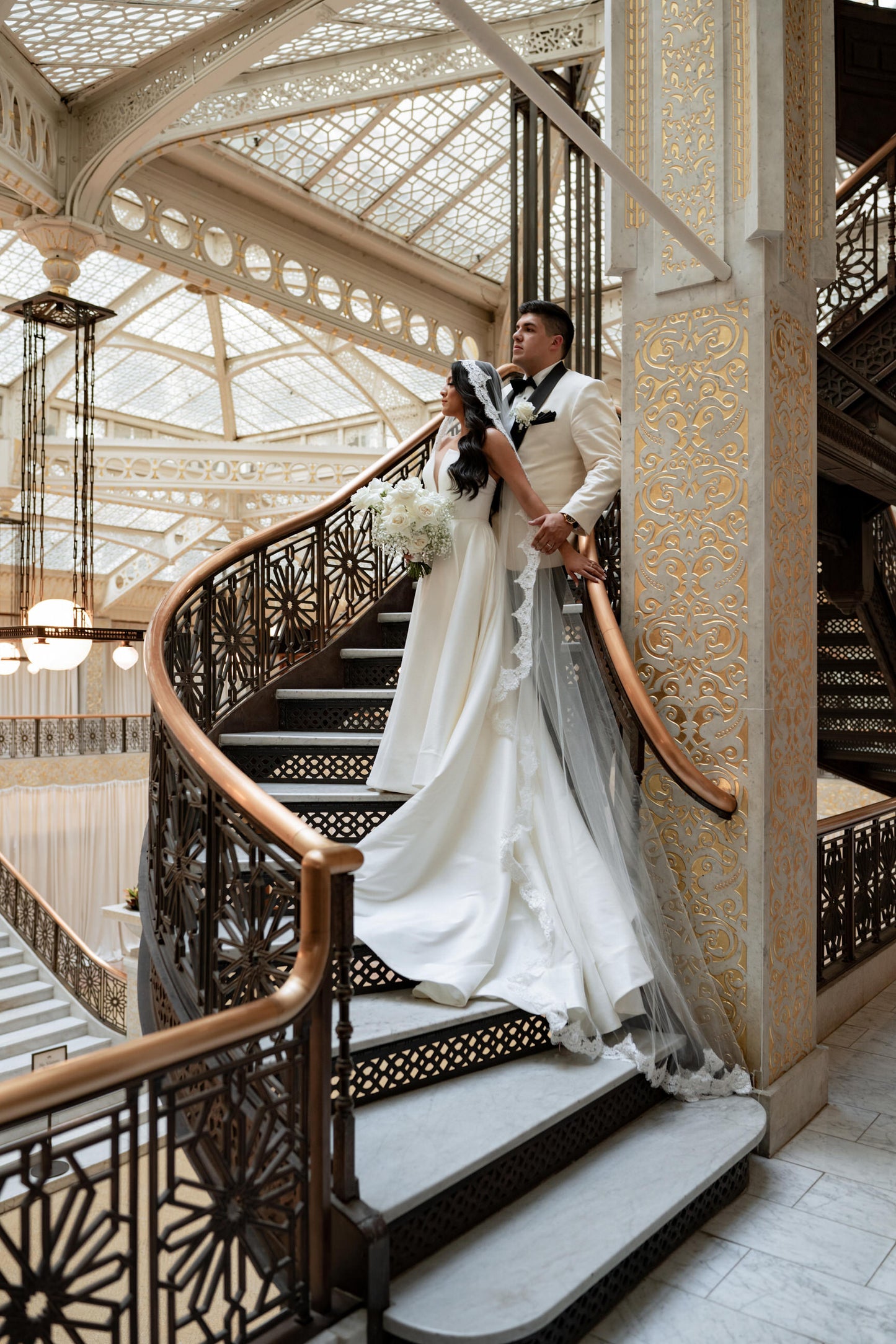 Chicago wedding with glam bride in long mantilla wedding veil cathedral length and groom in white suit