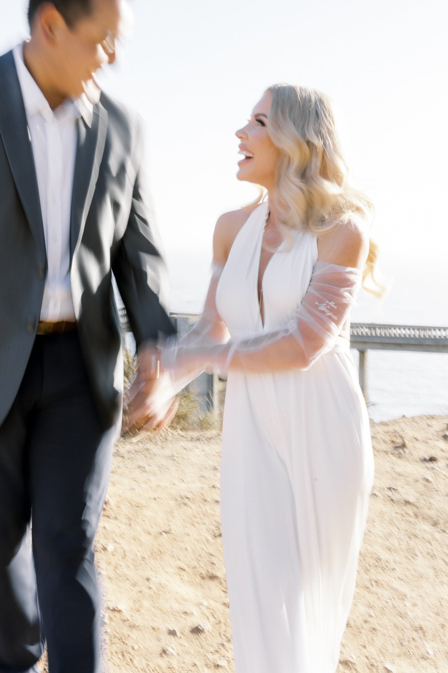 personalized ivory sheer glove set with custom embroidered text in script font and bride wearing jumpsuit