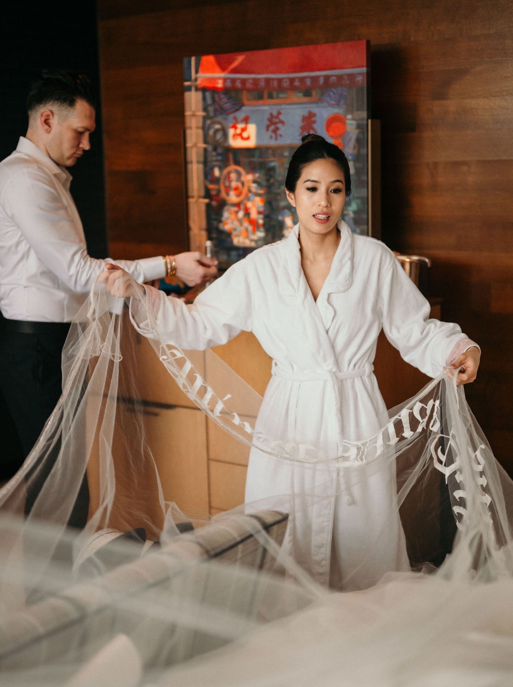 hong kong bride getting ready in a long royal length bridal veil with personalized written embroidery