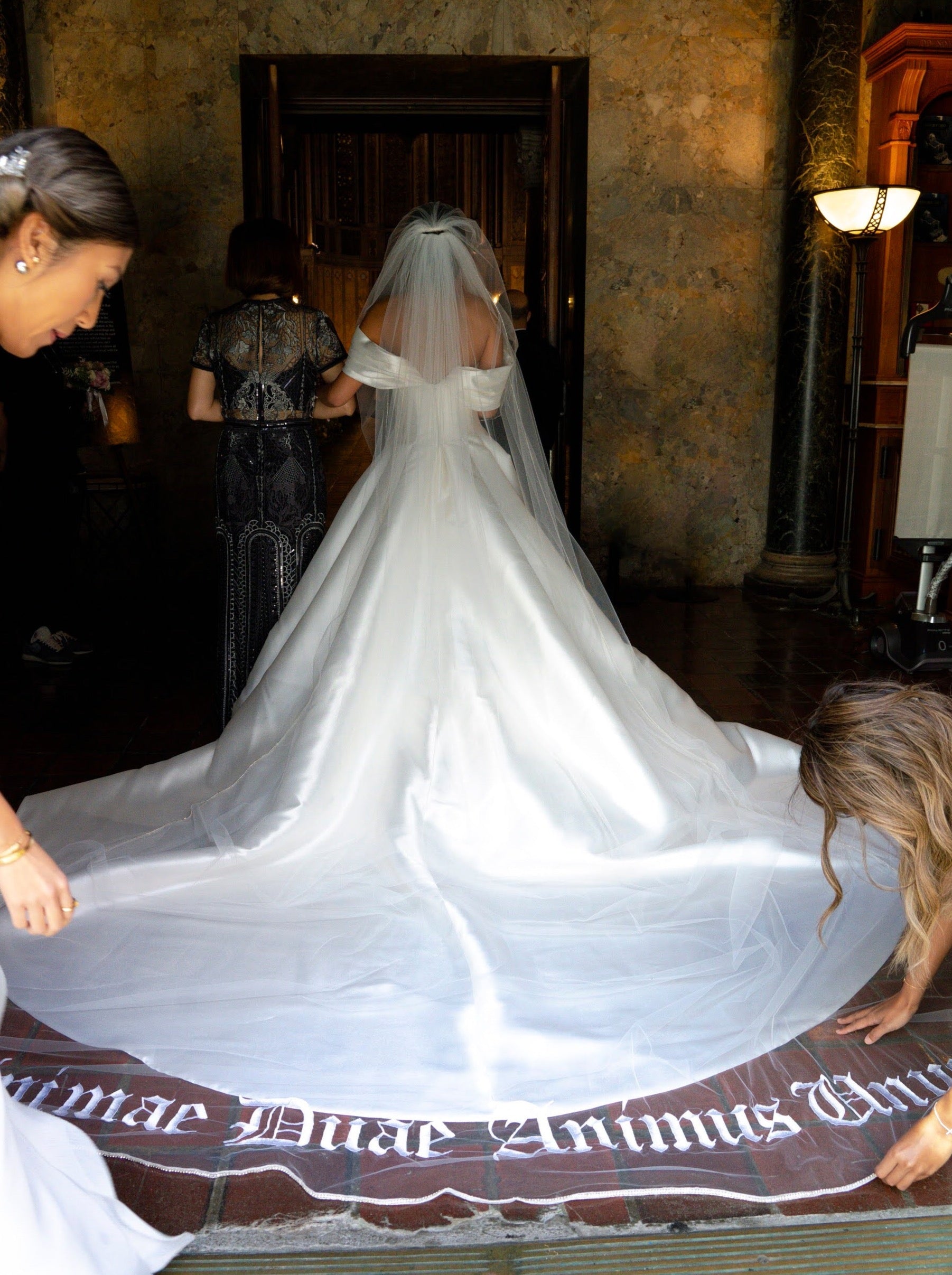 extra long and extravagant silk wedding gown and embroidered phrase wedding veil