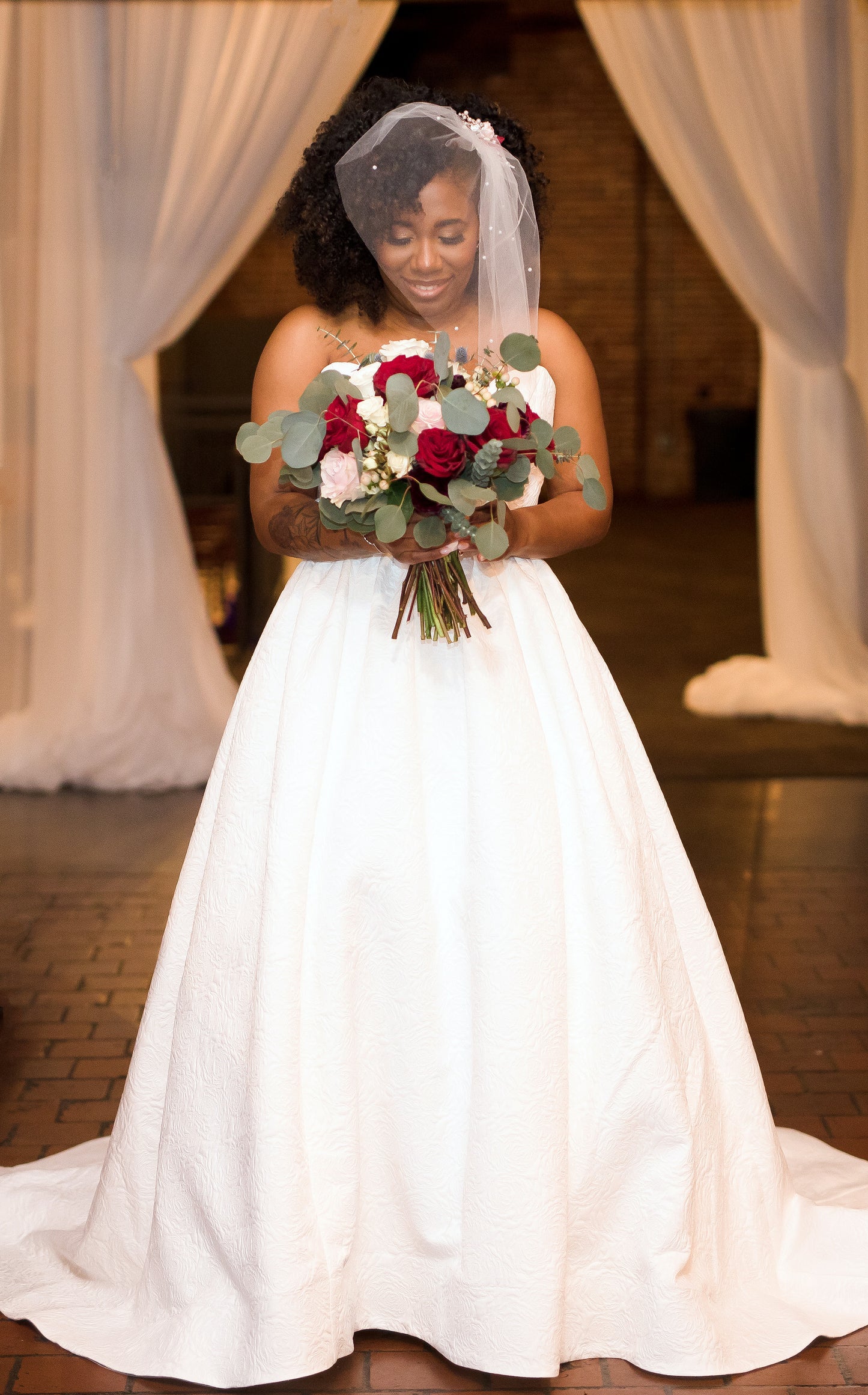 bride in birdcage wedding veil short that is chin length with scattered pearls and beaded comb hairpiece