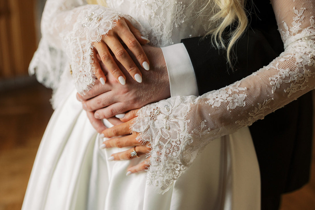 bride and groom's hands with bride in lace ivory bridal gloves fingerless