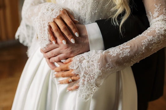 bride and groom's hands with bride in lace ivory bridal gloves fingerless