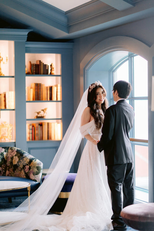 Disney princess inspired bride with butterfly tiara and long simple white wedding veil in blue room