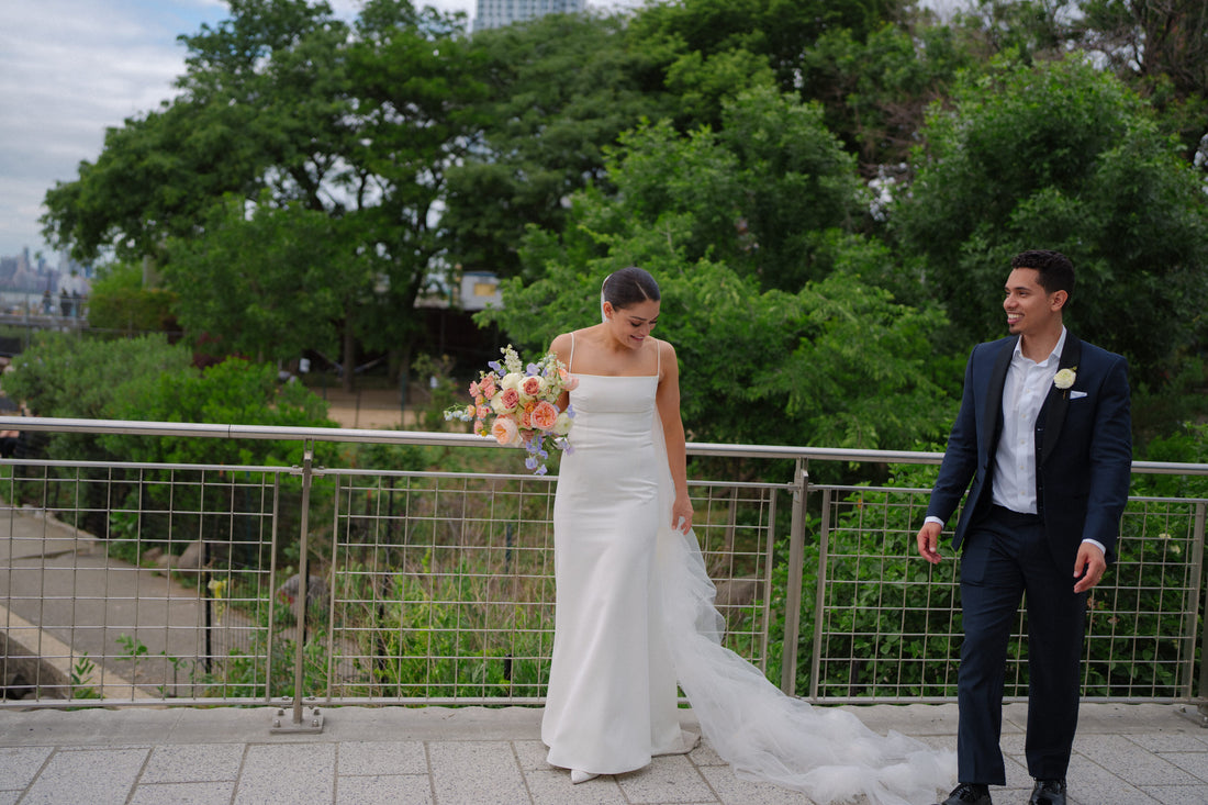 long dramatic scattered flower wedding veil cathedral length as bride shows off to groom