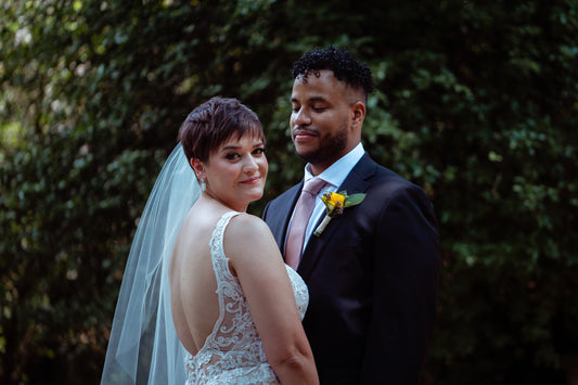 short haired bride with pixie haircut wearing short wedding veil and scoop back lace gown
