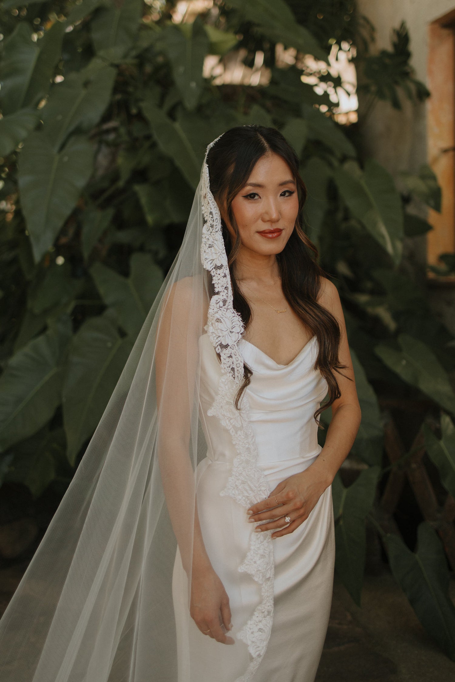 romantic mantilla length wedding veil with eyelash lace trim in light ivory for half up half down hairstyle