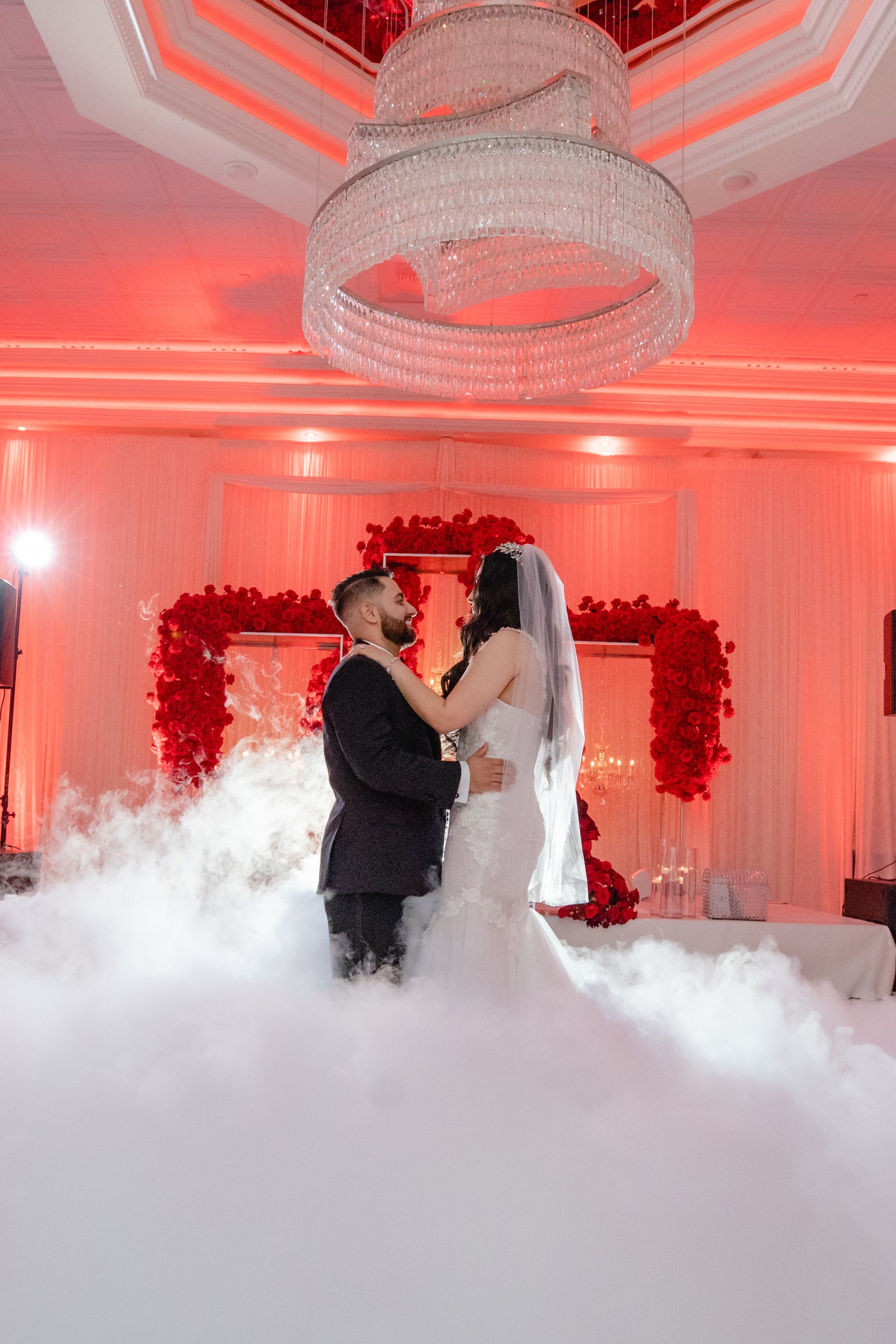 lavish reception for Persian couple with bride wearing fingertip length rhinestone wedding veil in downdo curls