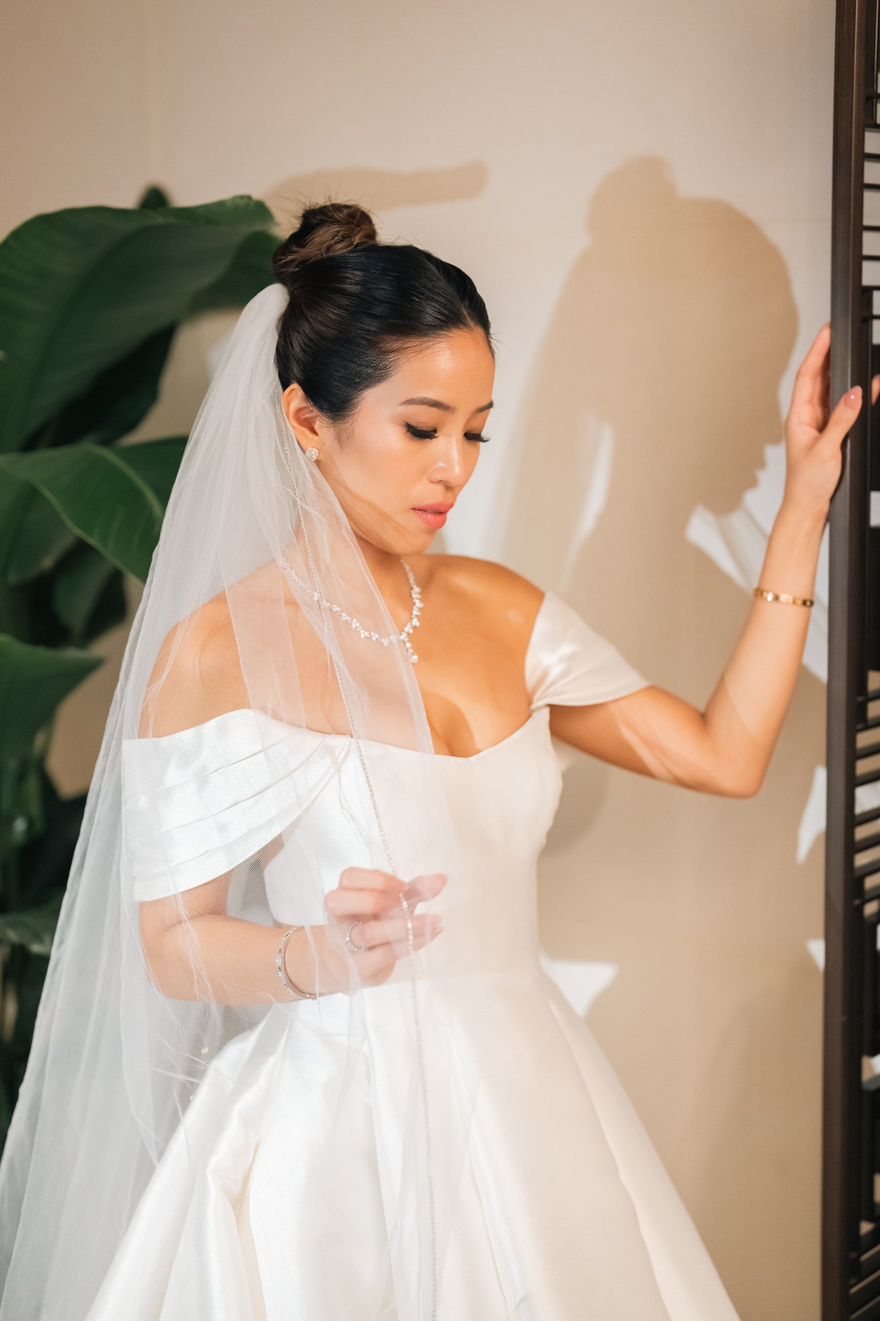 white rhinestone trim wedding veil on beautiful bride in satin ballgown