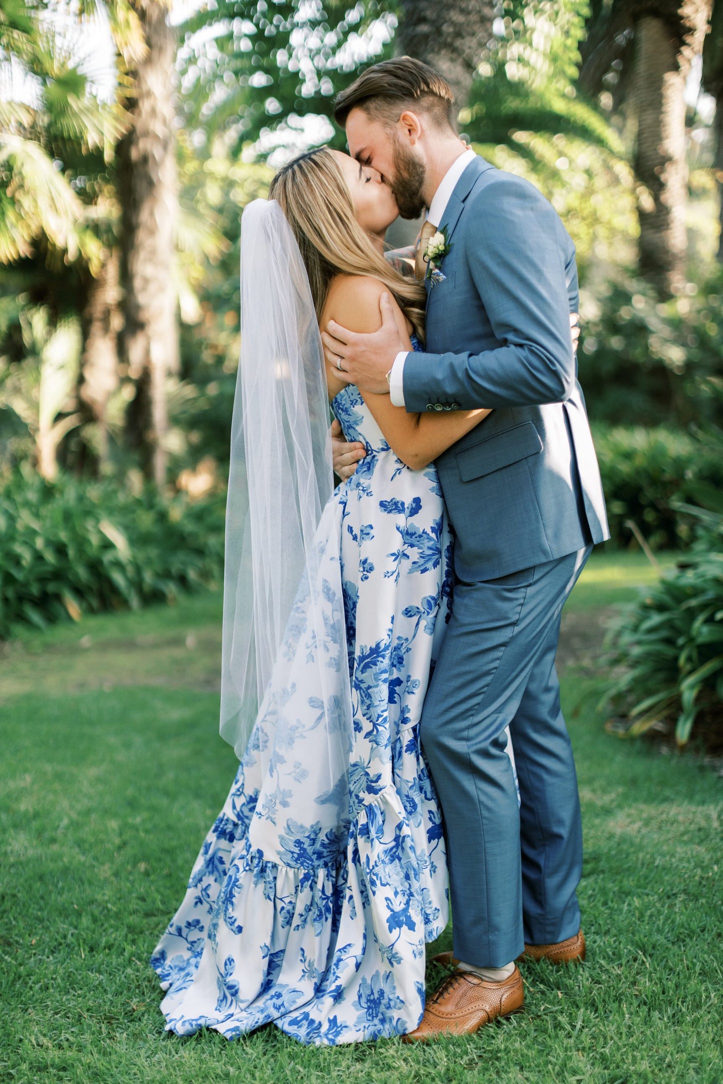 white and blue ruffle wedding gown with white ballet or calf length bridal veil one layers