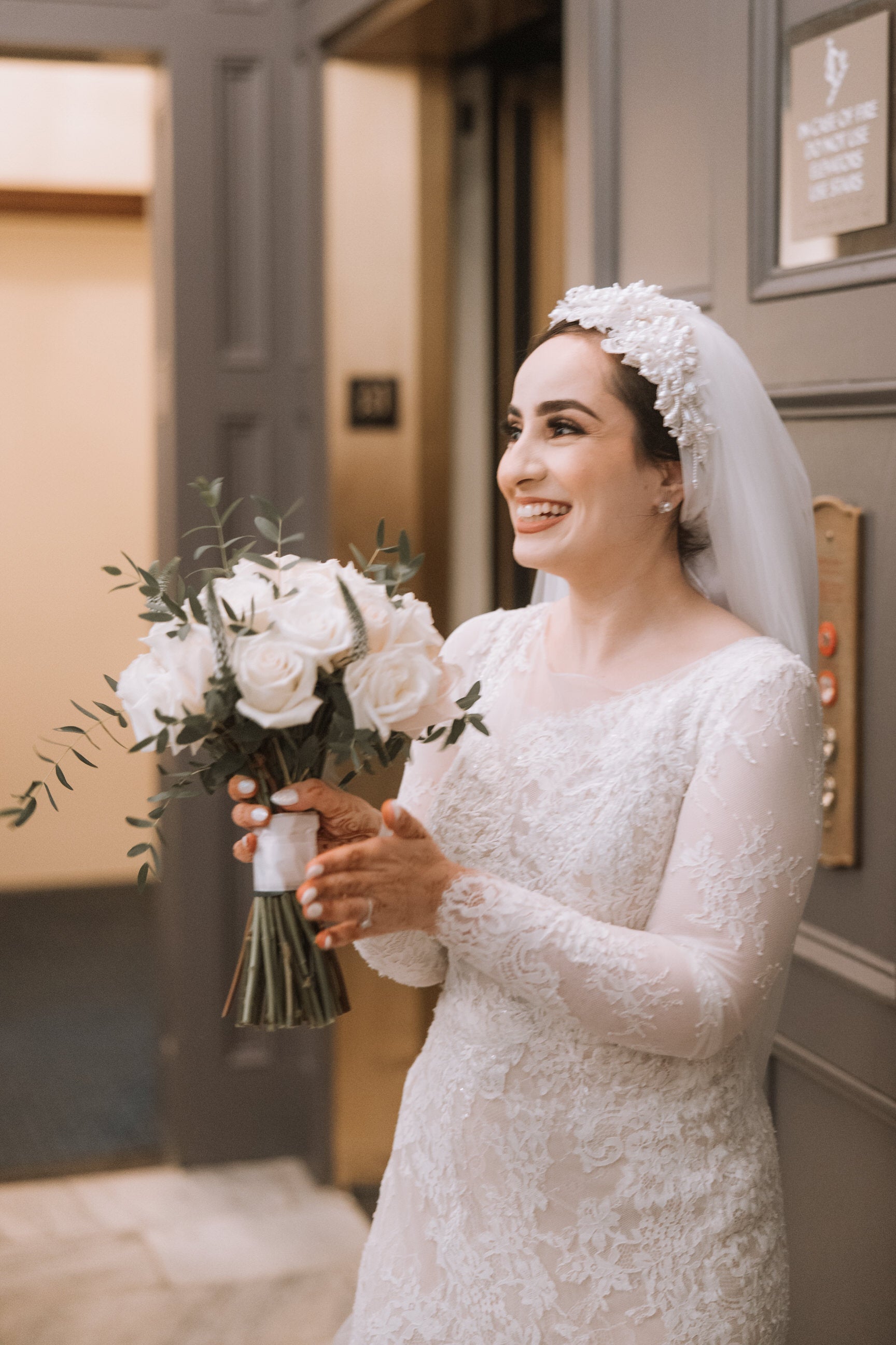 beautiful muslim bride in pearl headpiece with lace and henna on hands