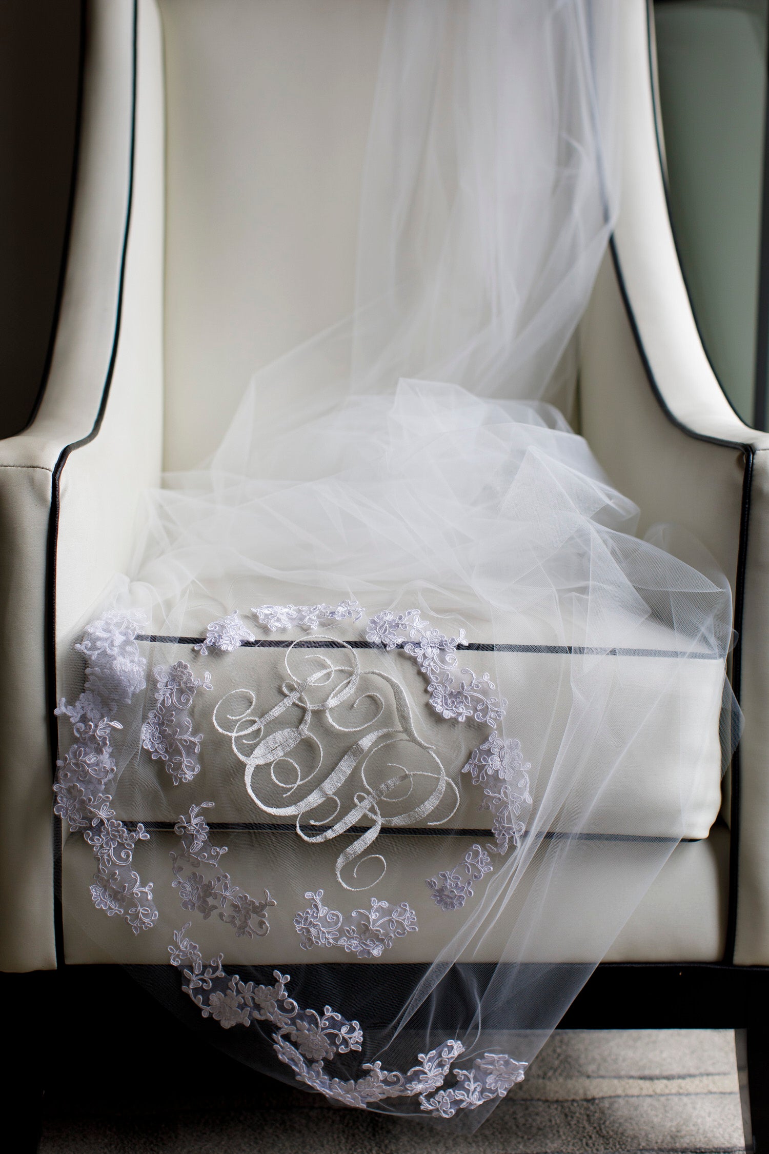 vintage inspired monogram embroidered long wedding veil draped over chair