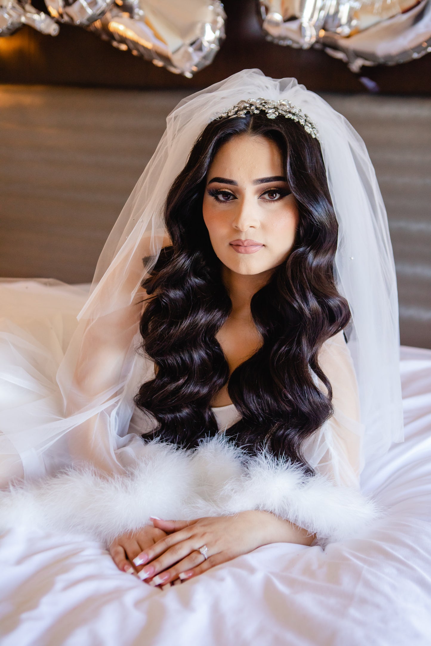 Middle eastern bride with defined curls and extra puffy two layer wedding veil with crystals headpiece 