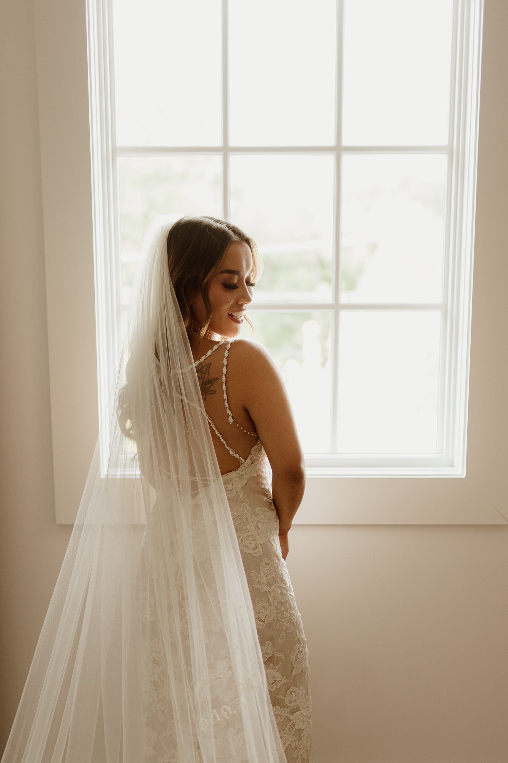 https://www.oneblushingbride.net/cdn/shop/files/elegantbridewearinglongcathedrallengthbridalveilwithsmallembroideredweddingdate533.jpg?v=1687370225&width=1946