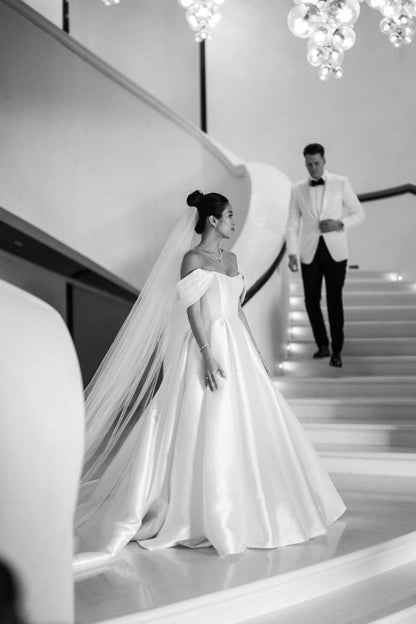 formal resort wedding with bride wearing a long royal length wedding veil sparkly trim edges