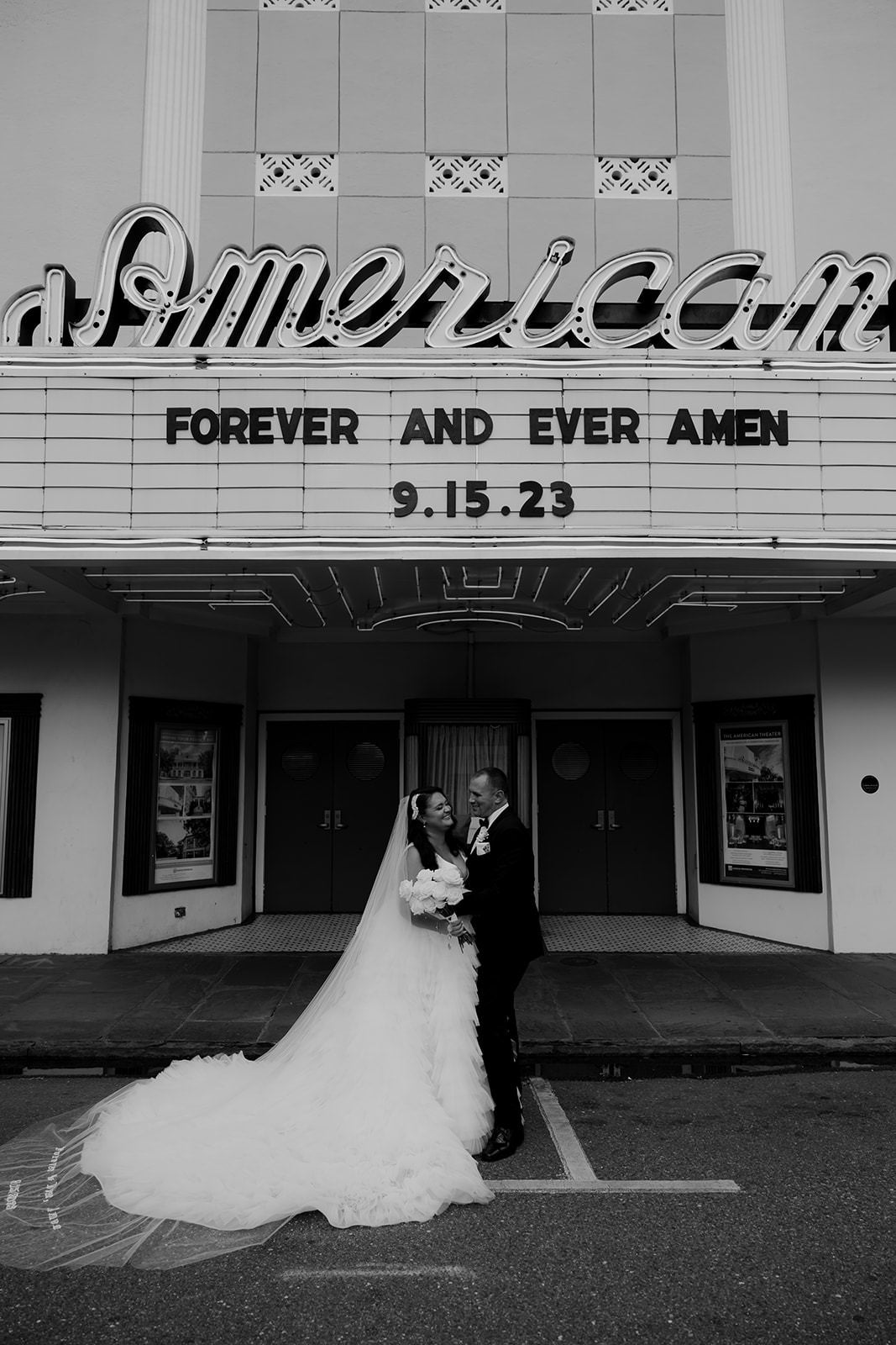 old fashioned movie theater with bride wearing long dramatic embroidered wedding veil with couple's initials