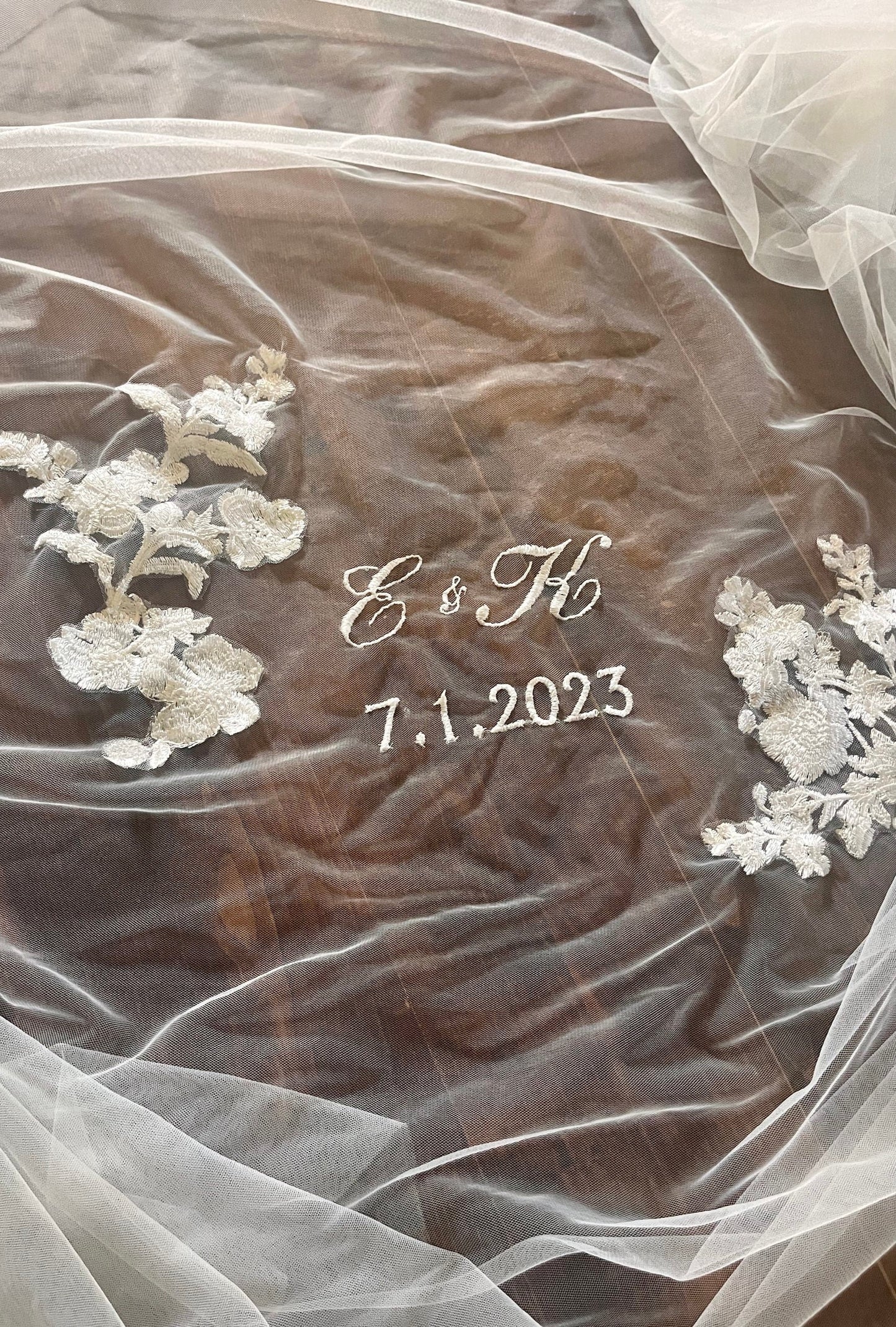 romantic script embroidery of engaged couple's initials and wedding date on a unity veil in white tulle