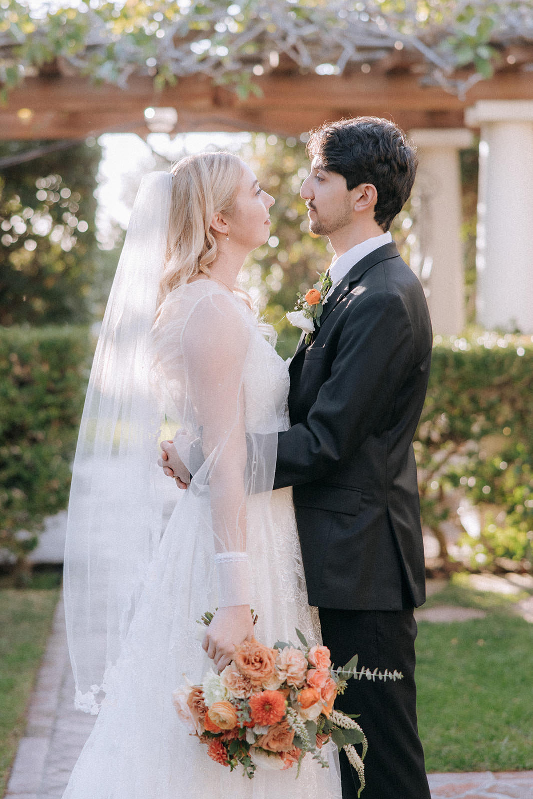botanical wedding inspiration with mid length leaf bridal veil and peach bouquet
