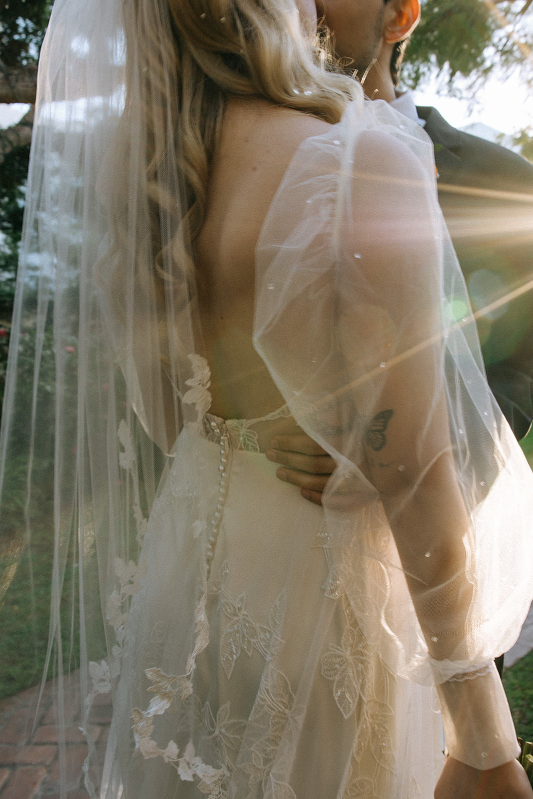 whimsical romantic puff sleeve bridal gown and leaf and vine fingertip veil