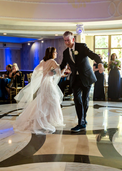 celestial wedding with bride dancing in floor length flowy wedding cape over blush bridal dress