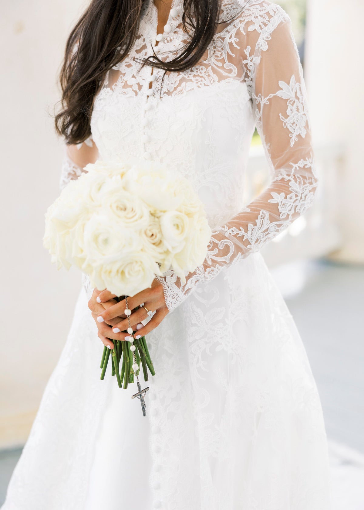 long sleeve lace bridal cape in ivory with buttons down front and white rose bouquet with rosary