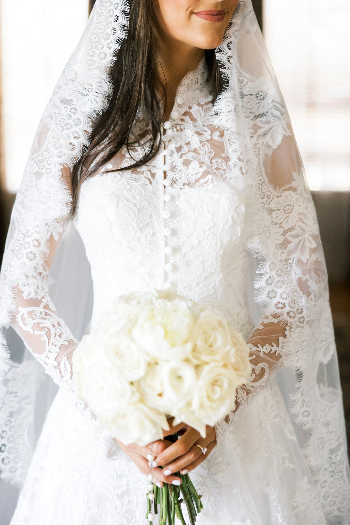 long sleeve fitted lace bridal cape in ivory with buttons down front and matching lace mantilla bridal veil