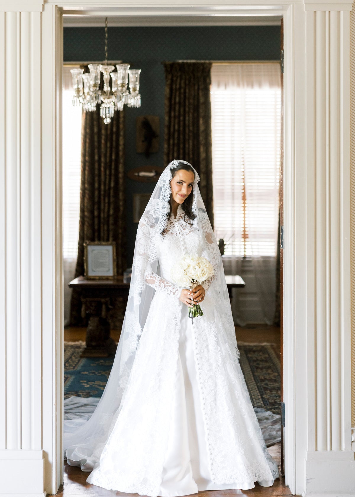 long sleeve lace bridal cape in ivory with buttons down front and matching lace mantilla bridal veil