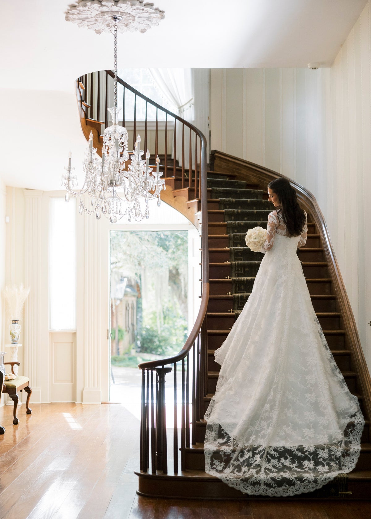 long sleeve lace bridal cape in ivory with train on bride in mansion 