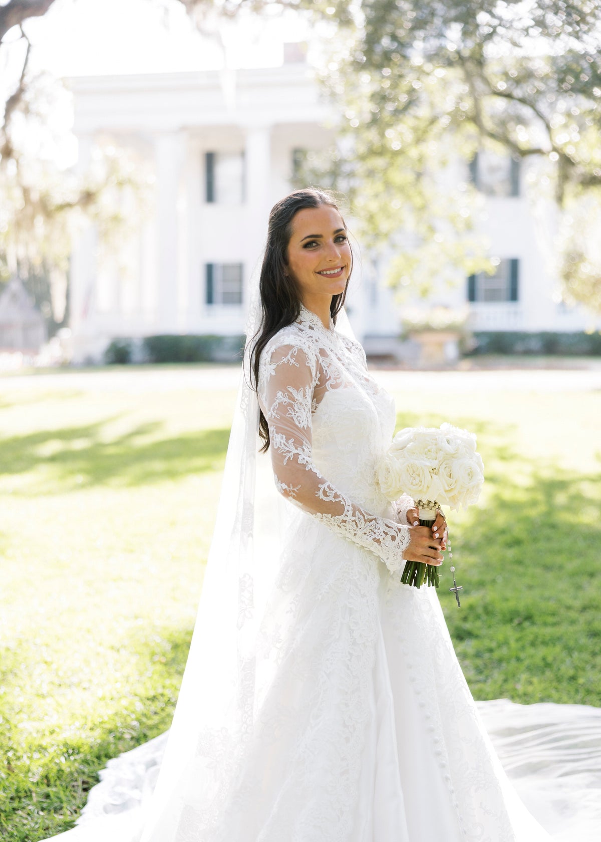 long sleeve lace bridal cape in ivory with buttons down front and matching lace mantilla bridal veil