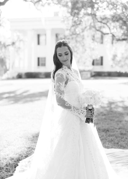 long sleeve lace bridal cape in ivory with buttons down front and matching lace mantilla bridal veil