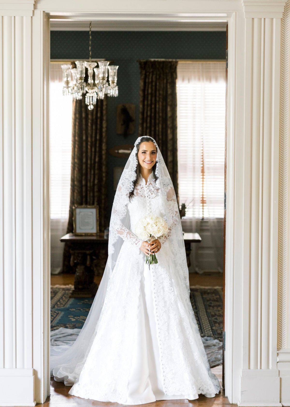 long sleeve lace bridal cape in ivory with buttons down front and matching lace mantilla bridal veil