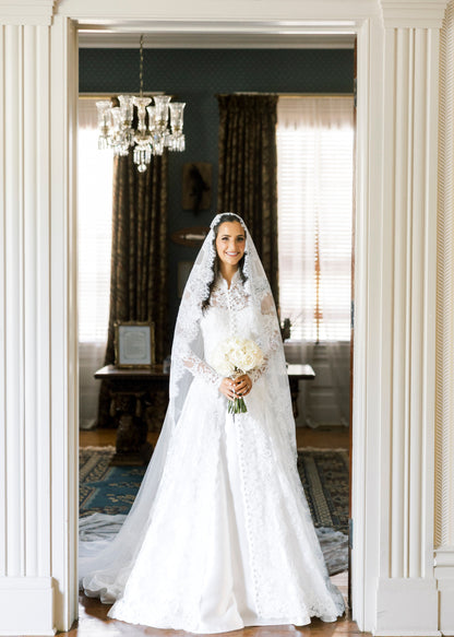 long sleeve lace bridal cape in ivory with buttons down front and matching lace mantilla bridal veil