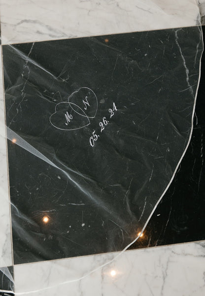 embroidered locked hearts in white thread stitching with couples initials on ribbon edged veil