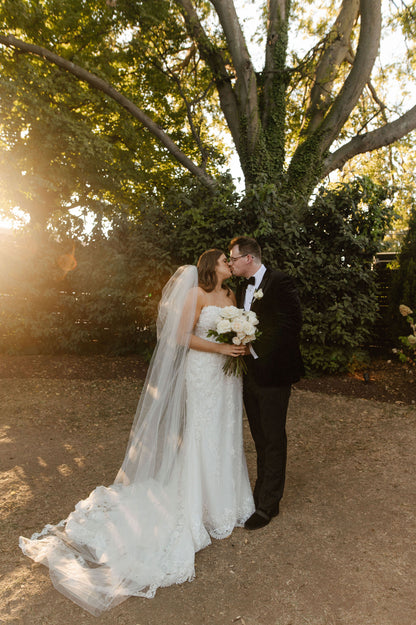 puffy two layer wedding veil with corded flower French lace edges at sunset