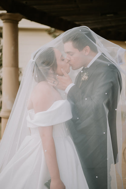 two layer pearl wedding veil cathedral length with comb in bride's low updo