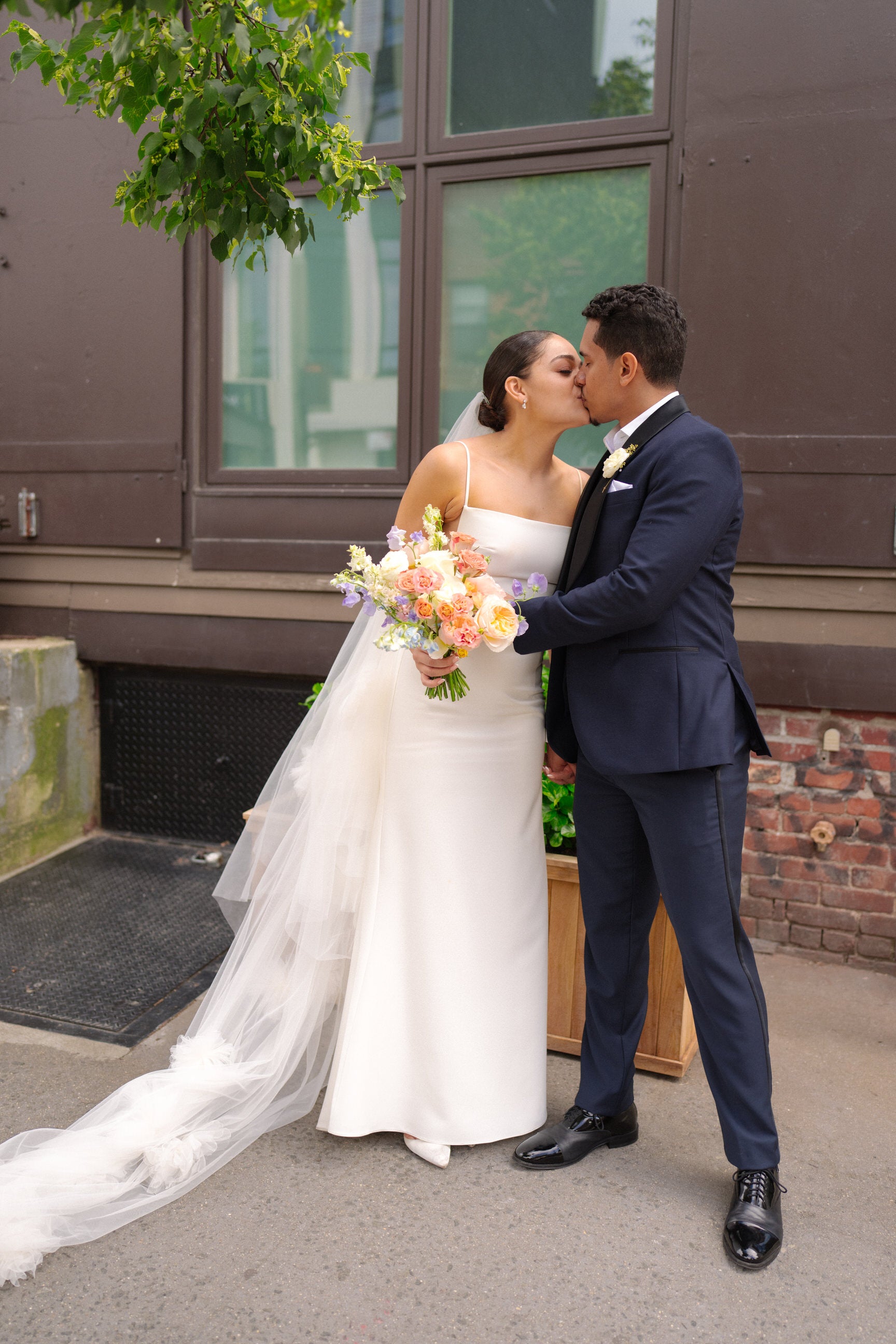 spring NY wedding with bride in white long cathedral veil with scattered handcrafted flowers