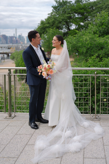 NY couple with bride in two layer chapel length bridal veil with large soft flowers in chiffon and tulle