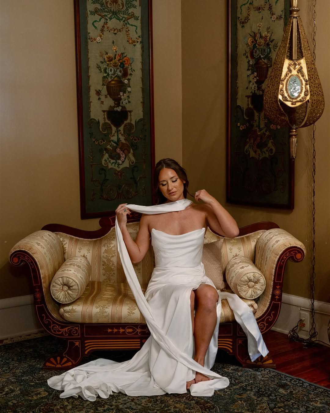 classic sexy bride on museum couch with satin silk bridal scarf on neck