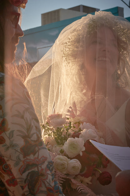 glimmer sparkly blusher wedding veil over bride''s face as she says vows