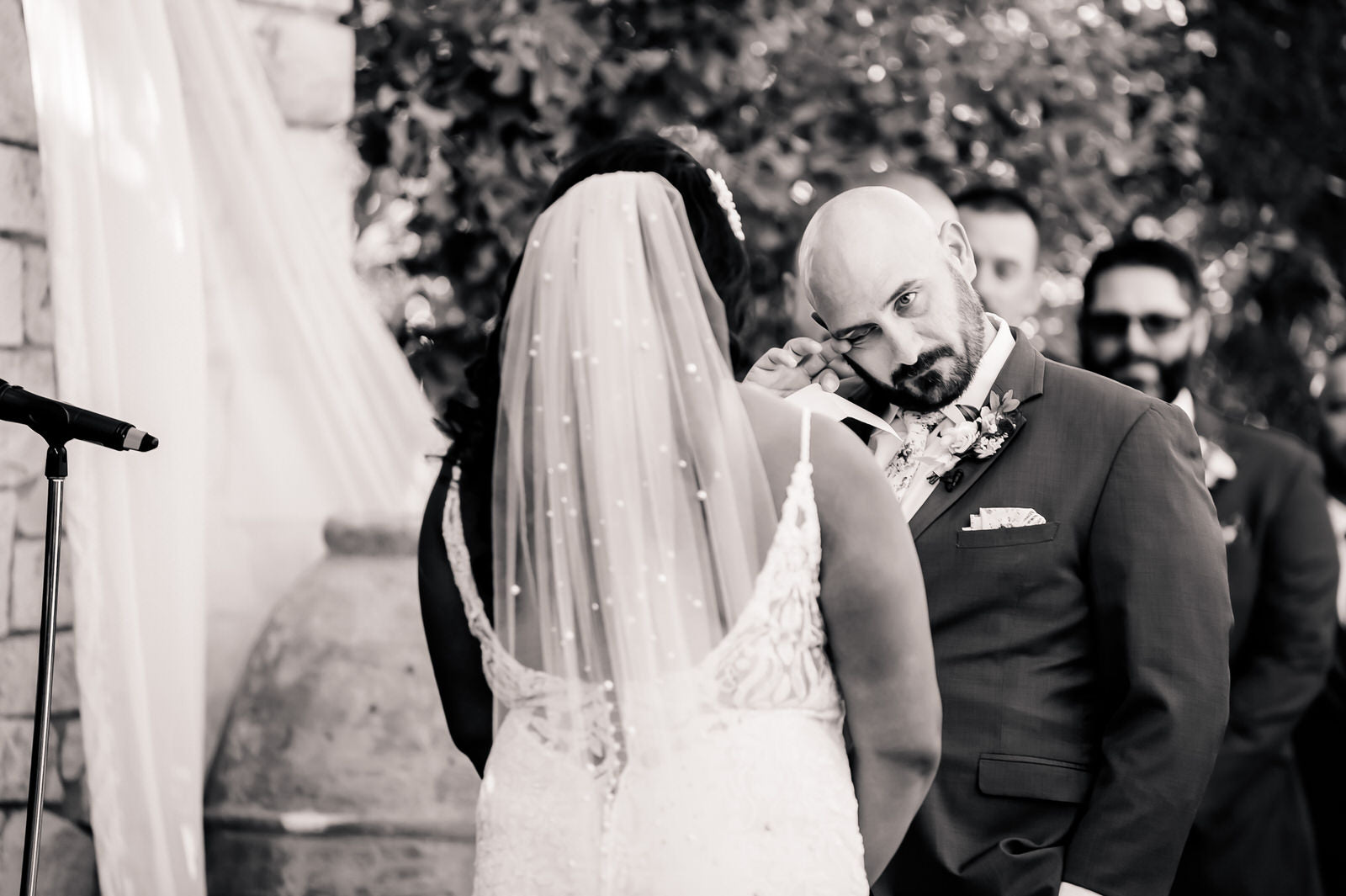 Load video: elegant bride wearing curled downdo hairstyle on wedding bride with long beaded pearl cathedral wedding veil in hair