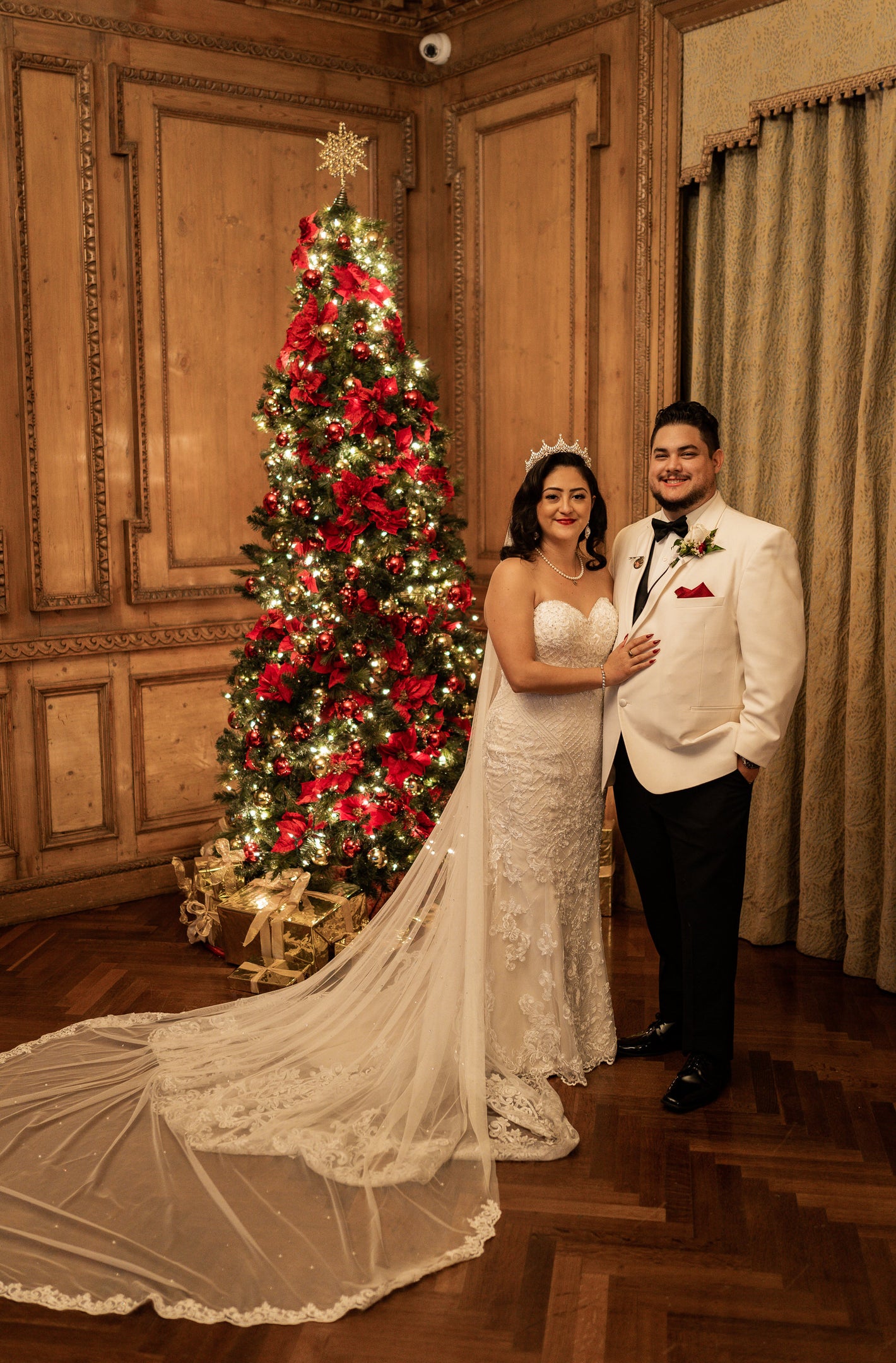 vintage 1920s christmas wedding with English net long royal length wedding veil with crystals and lace and decorated Christmas tree in background
