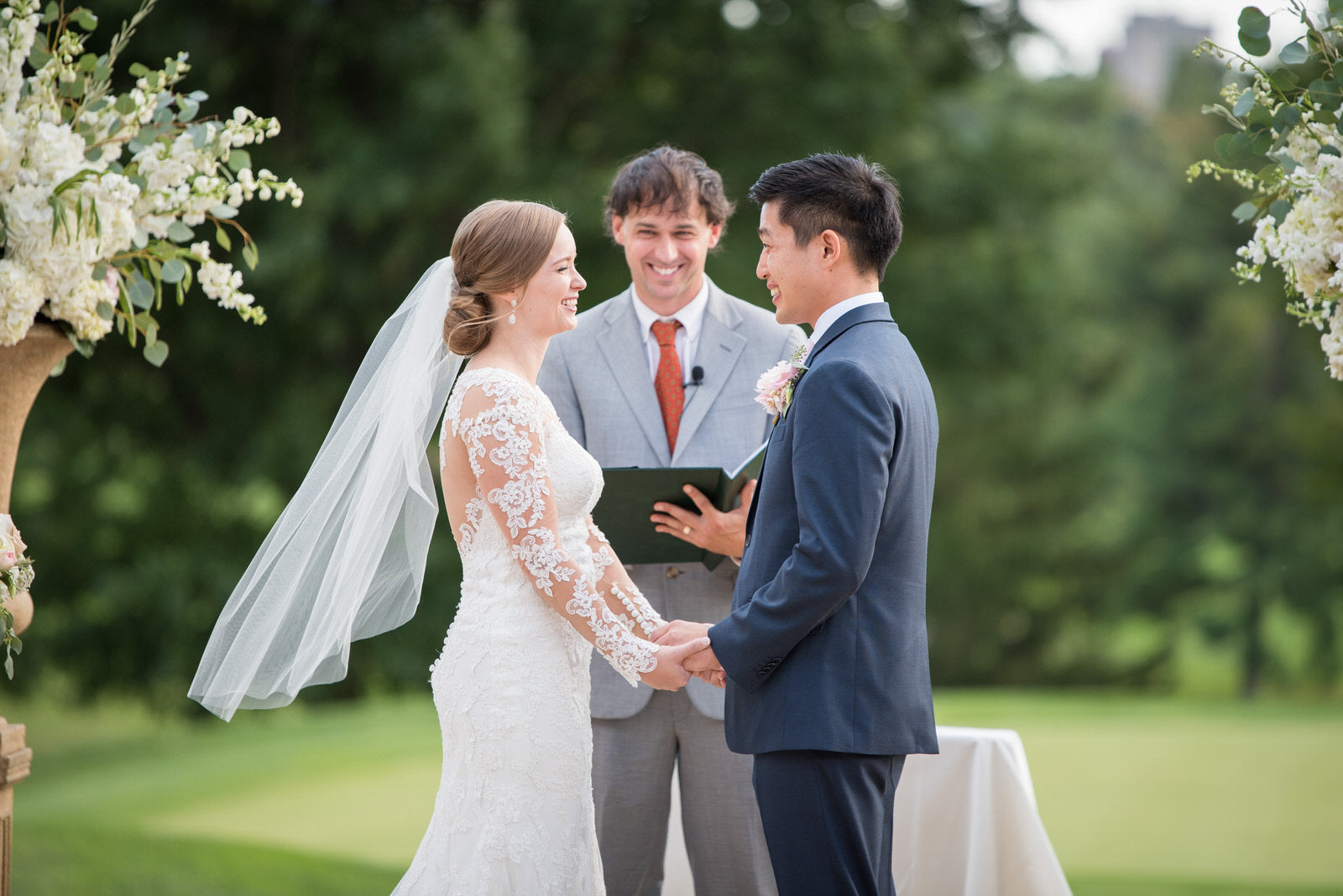 Load video: Jewish wedding ceremony with lace gown and simple raw edge medium length bridal veil