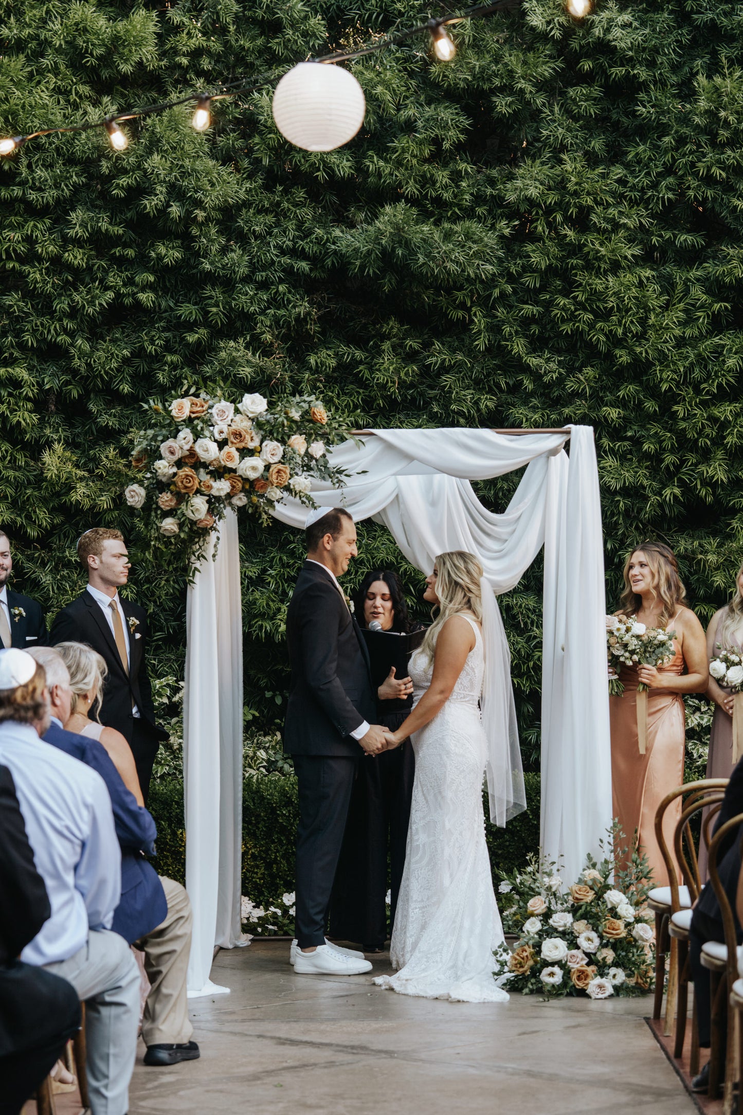 Jewish wedding ceremony under chuppah with simple fingertip cut edge veil on bride