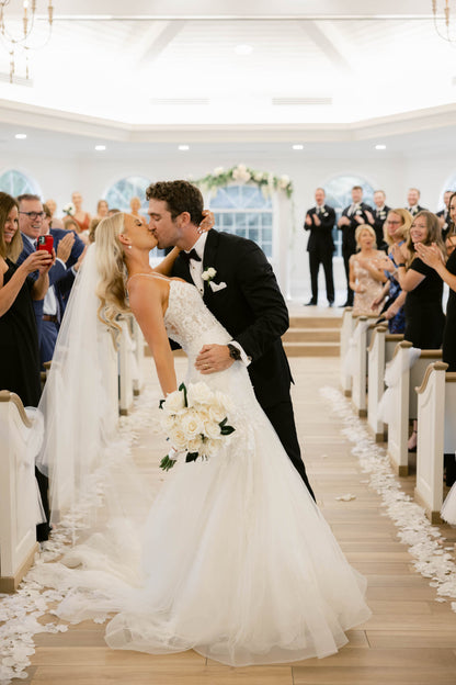 elegant knee length waltz wedding veil on bride in corset wedding dress holding white bouquet for Arlington wedding