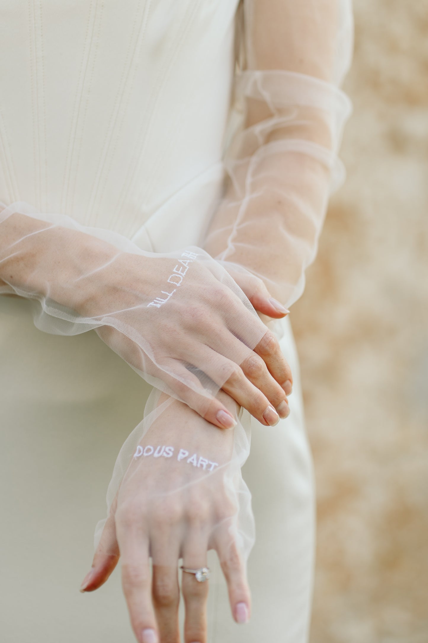 sheer white bridal glove sleeves set on bride wearing corset gown